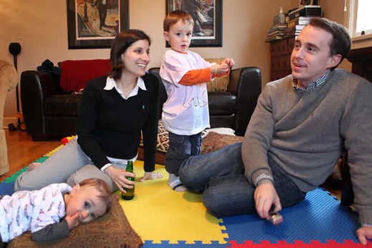 Bradley and Connie Tompkins relax with sons Jackson (left) and Dylan in their new home.
