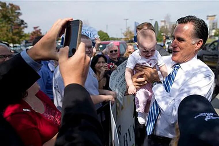 Republican presidential candidate, former Massachusetts Gov. Mitt Romney holds a baby after making a campaign stop at American Legion Post 176, Thursday, Sept. 27, 2012, in Springfield, Va.  (AP Photo / Evan Vucci)