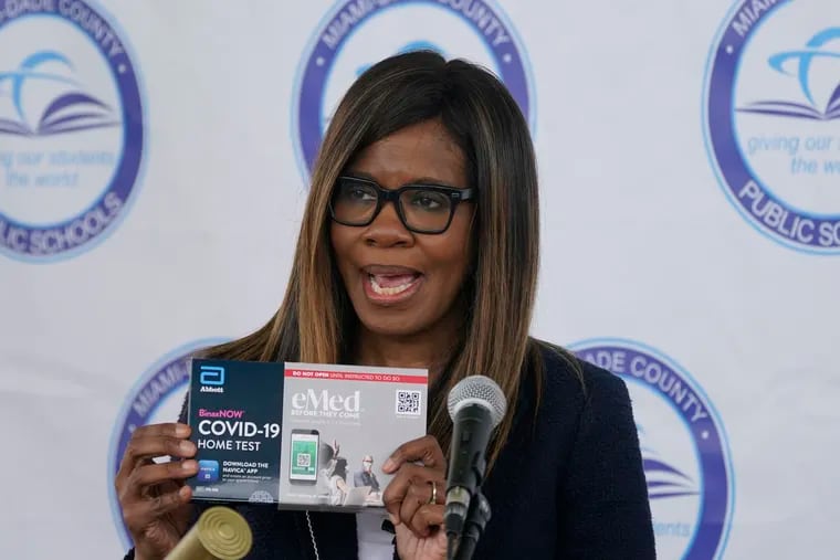 Dr. Patrice Harris, eMed Co-Founder and CEO, holds up a COVID-19 home rapid testing kit as she speaks during a news conference, Thursday, May 20, 2021, at the Frederick Douglass Elementary School in the Overtown neighborhood of Miami. The school district and eMed, a local Miami telehealth company partnered to provide 1,000 free tests to students, teachers in the neighborhood. (AP Photo/Wilfredo Lee)