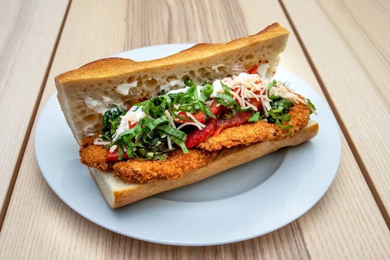 Monster Vegan offers four different sandwiches with its signature vegan fried chicken cutlet. The original, pictured here, is served with broccoli rabe, roasted red peppers, Follow Your Heart parmesan, and horseradish aioli on a crusty French baguette.