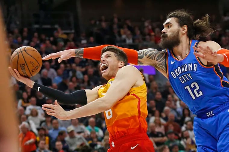 Kyle Korver tries to put up a shot as the Thunder's Steven Adams defends.