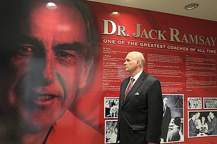 Attached to Hagan Arena at St. Joseph's is the Ramsay Basketball Center which includes this display on Dr. Jack. Current St. Joseph's Head Coach Phil Martelli looks over the display.   (Charles Fox/Staff Photographer)