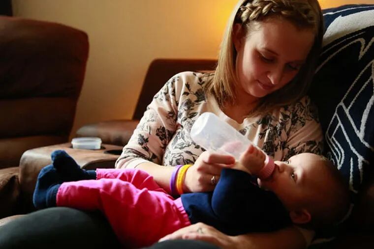 Jesi Paschen feeds daughter Radlee, 7 months, breast milk from a local donor at her home near Sumas, Whatcom County, Wash., on Friday, April 3, 2015. Paschen breastfed her first daughter but was unable to do the same for Radlee due to medications because of a blood clot after the birth.