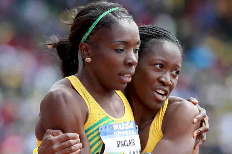 Jamaica's Kenia Sinclair (left) gets a hug from Simone Facey after they won the USA vs. the World women's sprint medley.
