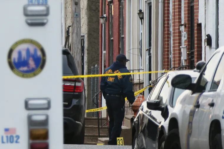 Crime scene investigators work at the scene in the 4600 block of Hawthorne Street in Philadelphia's Frankford section after a man apparently opened fire on officers on Thursday, Jan. 9, 2020. Police later shot and killed the man during an hour-long standoff, which began after state parole officers tried to arrest him on a warrant.