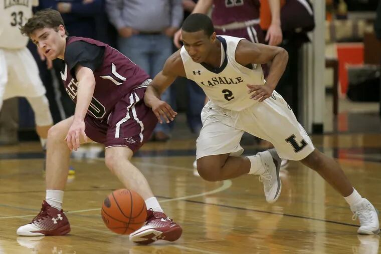 La Salle High’s Jarrod Stukes (right) goes after a loose ball with St. Joseph’s Prep’s Brian Griffin in February 2016.