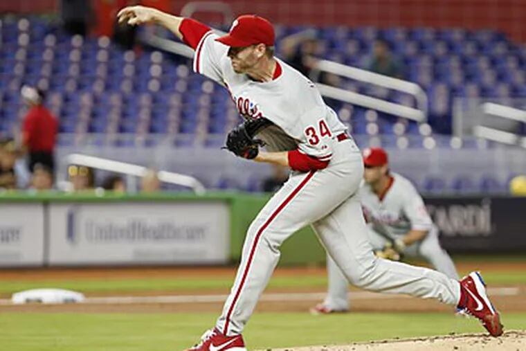 Roy Halladay pitched seven innings, allowed three runs and picked up the loss against the Marlins on Wednesday. (Wilfredo Lee/AP)
