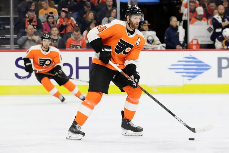 Flyers center Sean Couturier (foreground) and defenseman Ivan Provorov (background) will have tough defensive assignments Monday against visiting Boston.