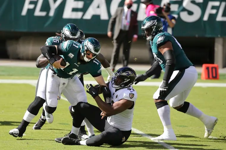 Eagles quarterback Carson Wentz is taken down by Baltimore Ravens defensive end Calais Campbell during the first quarter.