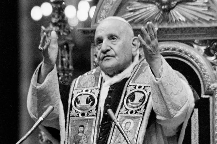 Pope John XXIII imparts his blessing at the closing ceremony of the Roman Catholic Ecumenical Council's first phase, at the Vatican in 1962.