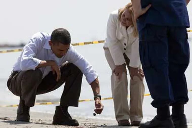 President Obama examining tar balls in the Gulf of Mexico in May.  He appears to be moving ahead quickly on his administration’s pledge to “clean up the mess“ at the Interior Department. (AP)