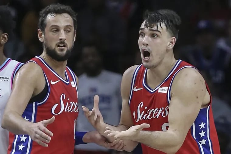 Dario Saric (right) reacts after a technical foul was called on him and gets support from teammate Marco Belinelli.