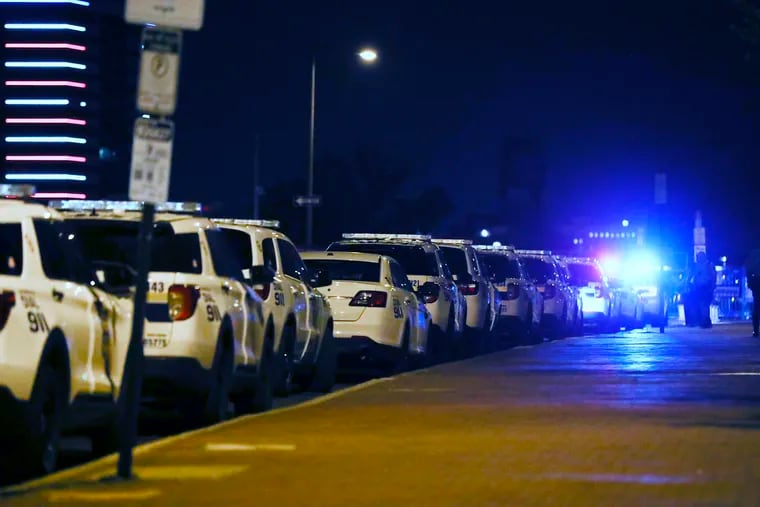 A row of police cars line Chestnut Street by Front Street on Monday.