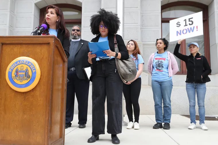 Anna Ortega (left), of Make the Road Pa., speaks during a rally to fight for the end of preemption, the law that prevents municipalities from setting local laws already addressed by state legislation, and to raise the state and local minimum wage in Philadelphia on Tuesday, May 9, 2023. Ortega was joined by local and state representatives at the event.