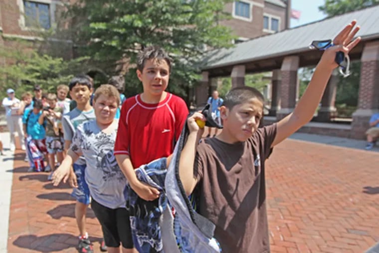 In line for lunch at Camp Sequoia, at Hill School in Pottstown, Matt Breen, 12, of Grosse Pointe, Mich., raises his hand to answer a question. (Michael Bryant / Staff Photographer)