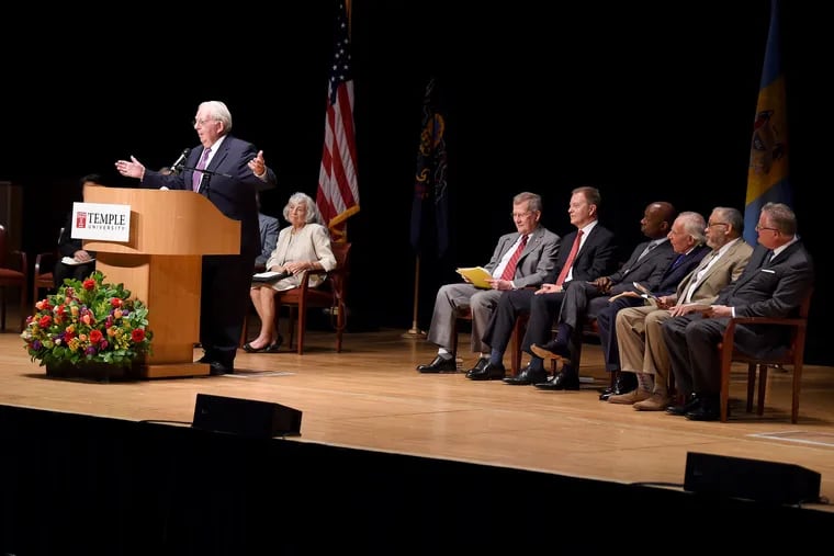 Bill Giles, chairman emeritus and former part-owner of the Phillies, speaks during a memorial service Sunday for Lew Klein, a Philadelphia broadcasting pioneer and former educator at Temple. Klein's widow, Janet, is seated behind Giles, with other dignitaries, including former Philadelphia Police Commissioner Charles Ramsey (second from right) and David Boardman (first from right), dean of Temple's Lew Klein College of Media and Communication, on the dais.