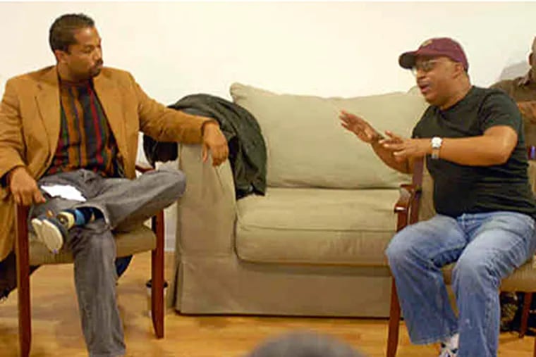 Brothers Network cofounder Tony Monteiro has the floor as Tony Williams listens. Originally conceived as a book club, the organization has swelled to over 200 members in the last year. (Ron Tarver / Staff)