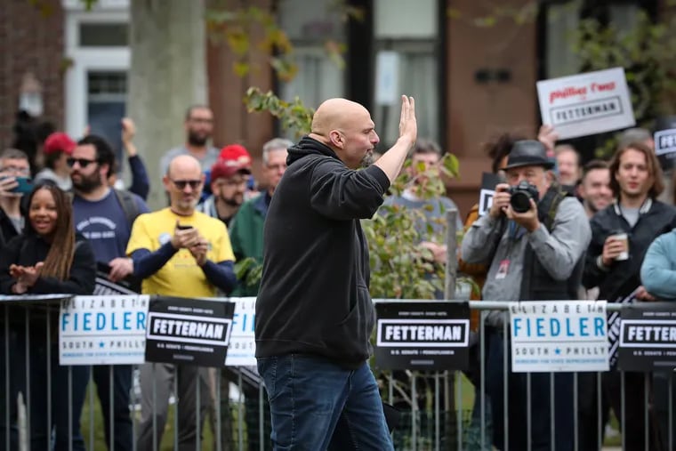 U.S. Senate candidate John Fetterman waves to the crowd during a rally at Dickinson Square Park in South Philadelphia.
