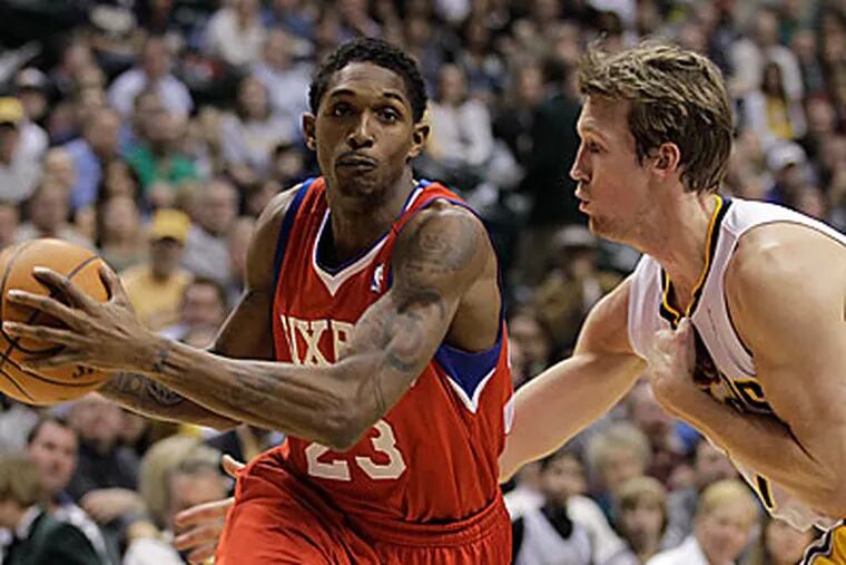 Philadelphia 76ers guard Lou Williams, left, drives to the basket against Indiana Pacers forward Mike Dunleavy. (AP Photo/Darron Cummings)
