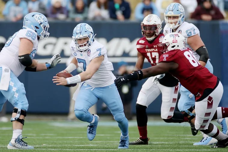 North Carolina quarterback Sam Howell scrambled away from Temple defensive tackle Ifeanyi Maijeh during last year's Military Bowl.