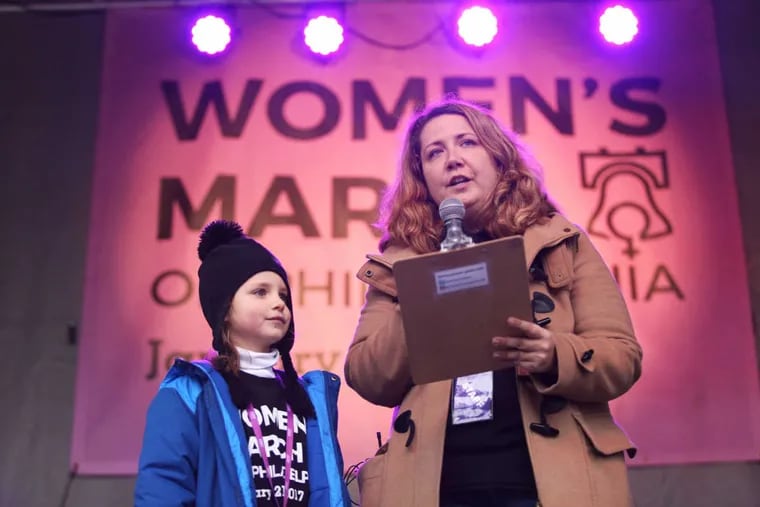 Emily Cooper-Morse speaks next to her daughter, Izzy Morse, 7, to kick off the Philly Women Rally January 21, 2017.