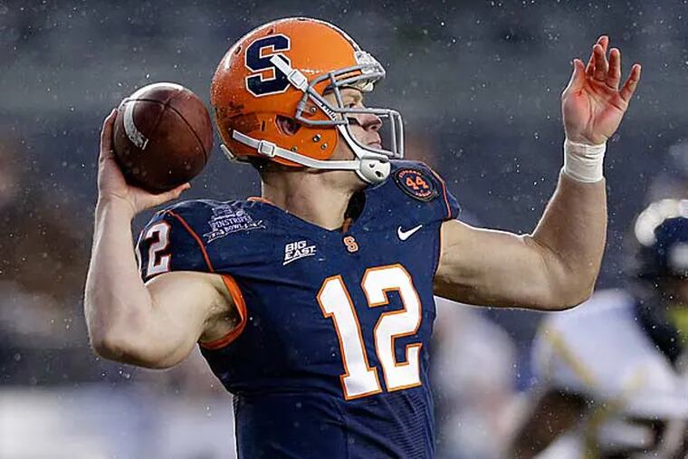 Syracuse quarterback Ryan Nassib (12) drops back for a pass against West Virginia during the Pinstripe Bowl NCAA college football game at Yankee Stadium in New York, Saturday, Dec. 29, 2012. (Kathy Willens/AP)