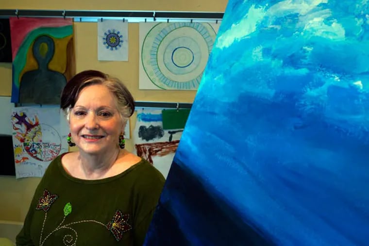 Jane Avila, founder of The Art Station in Fort Worth, Texas, poses for a portrait Sept. 30, 2014 with various finished and unfinished client art work. The Art Station is one of the few places that offers art therapy in North Texas. (Ron Baselice/The Dallas Morning News/TNS)