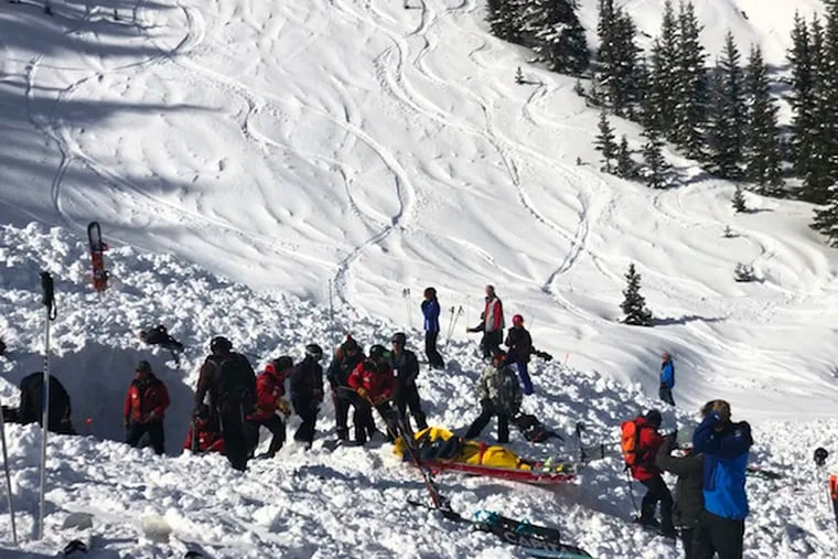 People search for victims after an avalanche buried multiple people near the highest peak of Taos Ski Valley, one of the biggest resorts in New Mexico, on Thursday.
