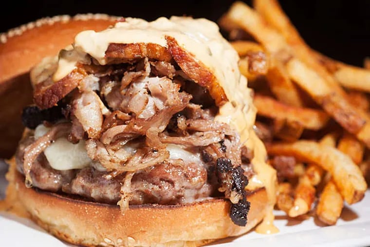 Stick with the meals on a bun: The Porkenstein is a house-ground pork-butt patty topped with clove-brined, apple-smoked ham, pulled pork, and a braised, crisped belly slice. (ED HILLE / Staff Photographer)