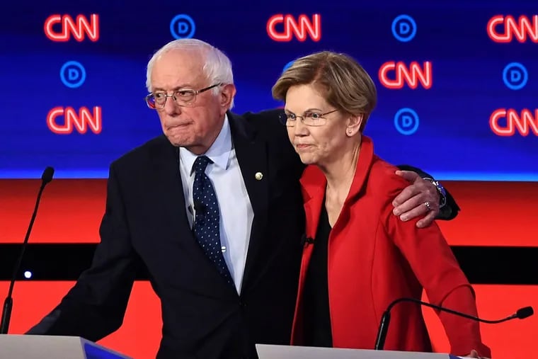 In this file photo taken on July 30, 2019, Democratic presidential hopefuls Sen. Bernie Sanders (I-Vt.), left, and Sen. Elizabeth Warren (D-Mass.) after participating in the first round of the second Democratic primary debate of the 2020 presidential campaign season in Detroit. Both have called for big tax increases on the super wealthy. (Brendan Smialowski/AFP/Getty Images/TNS)