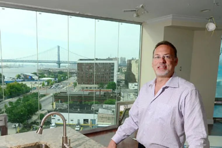 Developer Michael Samschick stands in an apartment overlooking the Delaware waterfront in Philadelphia. He is developing two buildings into 192 apartments. (Clem Murray / Staff Photographer)