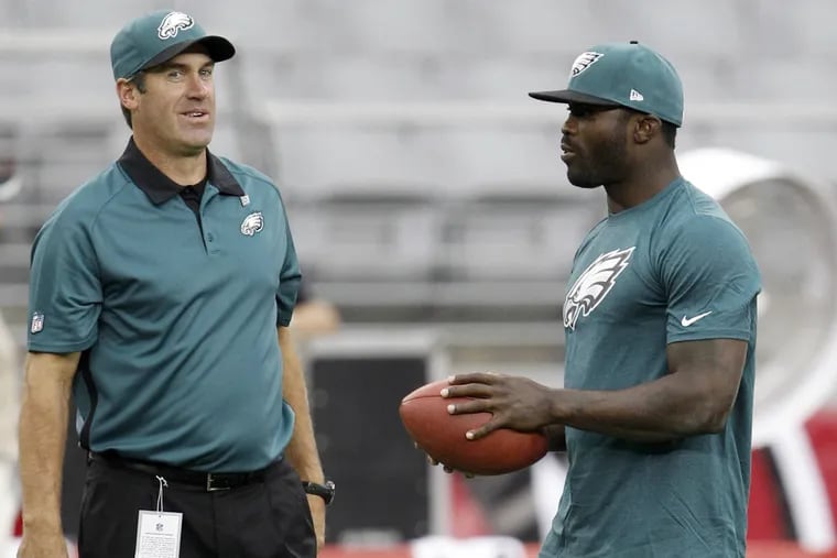 Doug Pederson (left), shown with then-quarterback Michael Vick in 2012, when he was the Eagles' quarterbacks coach, is now working as Kansas City's offensive coordinator. (Yong Kim / Staff Photographer)