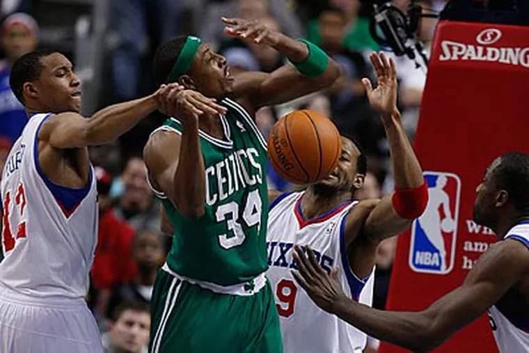Evan Turner knocks the ball out of the hands of Paul Pierce as Andre Iguodala and Elton Brand defend. (Ron Cortes/Staff Photographer)