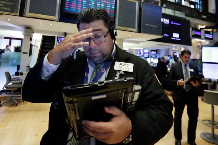 Trader Michael Capolino works on the floor of the New York Stock Exchange.