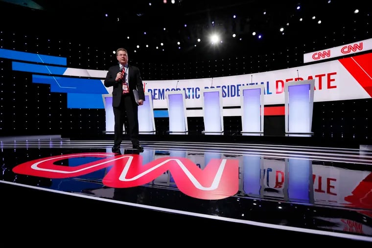 A CNN employee stands on the stage, Tuesday, Jan. 14, 2020, before a Democratic presidential primary debate hosted by CNN and the Des Moines Register in Des Moines, Iowa.