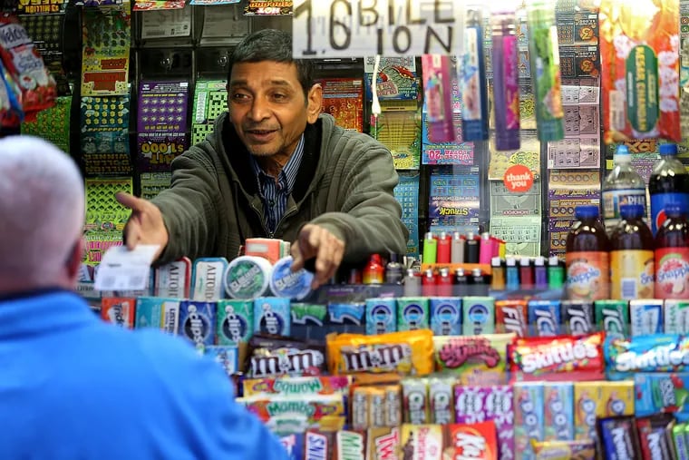 News stand operator John Patel sells a Mega Millions ticket from his kiosk near City Hall in Philadelphia With a jackpot at $1.6 billion, Patel said he sold a lot of tickets in the morning.