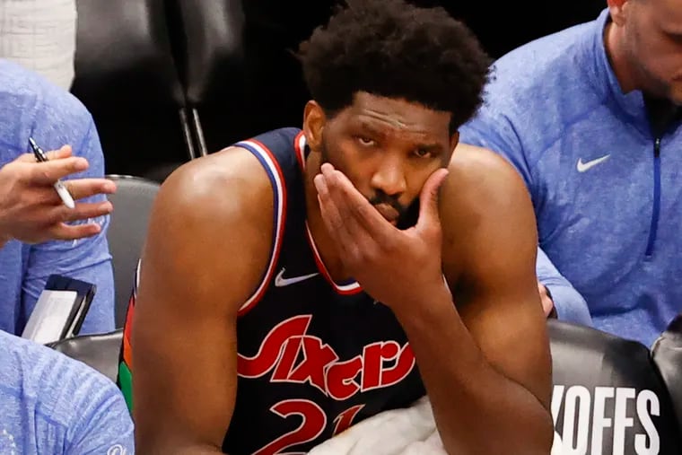 Sixers center Joel Embiid sits on the bench Thursday night after taking an elbow to his face against the Raptors in Game 6.
