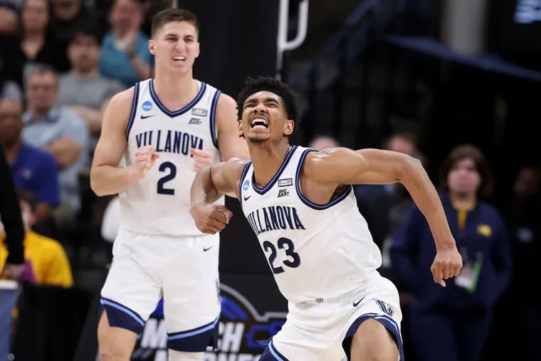 Jermaine Samuels, right, of Villanova celebrates after drawing an offensive foul on Michigan during the 2nd half of their game in the NCAA Tournament on March 24, 2022 at AT&T Arena in San Antonio, Texas.  Collin Gillespie is left.