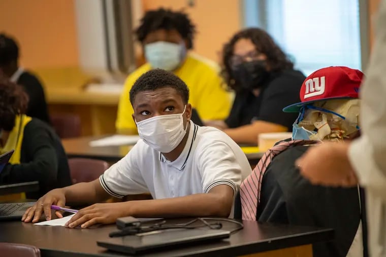 Eighth grade student Ethan Palmer, 13, in science class at the Benjamin Banneker Preparatory Charter School in Westampton. He’s sitting next to a skeleton “Dexter” that his teacher put in the classroom as a morale booster.