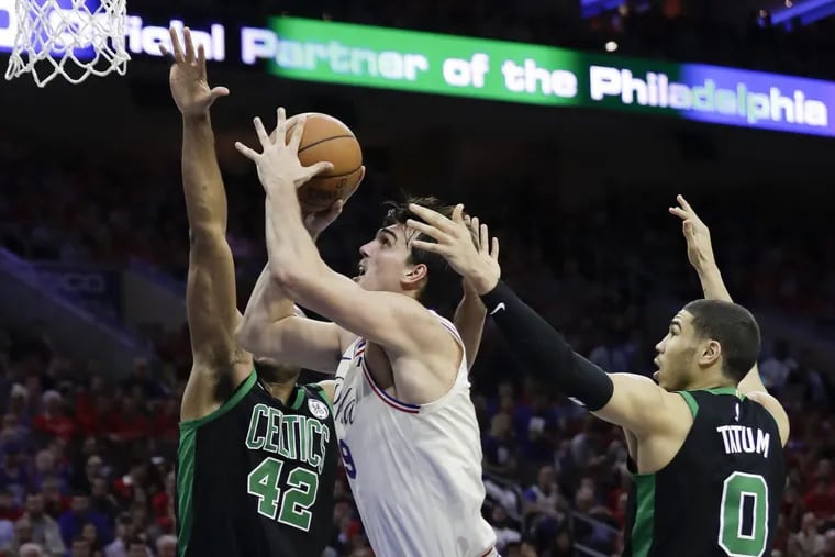 Sixers forward Dario Saric drives to the basket past the Celtics’ Al Horford (left) and Jayson Tatum on Monday.