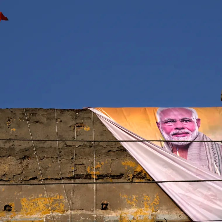 A policeman keeps watch from the roof of a building during a campaign rally by Indian Prime Minister Narendra Modi for his Bharatiya Janata Party (BJP) ahead of parliamentary elections in Ghaziabad, India, April 6, 2024. Modi is campaigning for a third term in the general election starting Friday.
