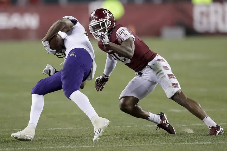 Temple’s Artrel Foster goes after East Carolina wide receiver Jimmy Williams during a game last November.