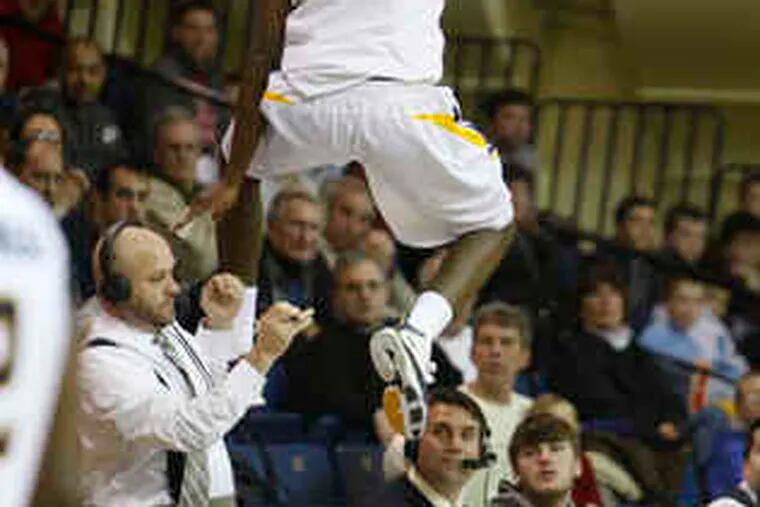 La Salle's Kimmani Barrett flies over the media table while trying to save a loose ball at Tom Gola Arena.