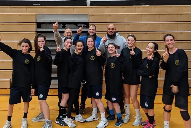 Charles Howard (back row, right) and daughter Anna (front row, second from right) and members of their Main Line Girls Basketball Association squad.
