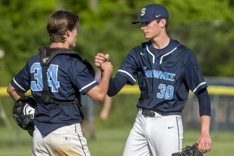 Shawnee starter Dan Frake (right) is congratulated by catcher Colin Wetterau (left) as he leaves the game after 4-2/3 innings, eventually getting the win as they defeat Washington Twp. 6-2, advancing to 2nd round of SJ Group IV Tournament May 21, 2018.