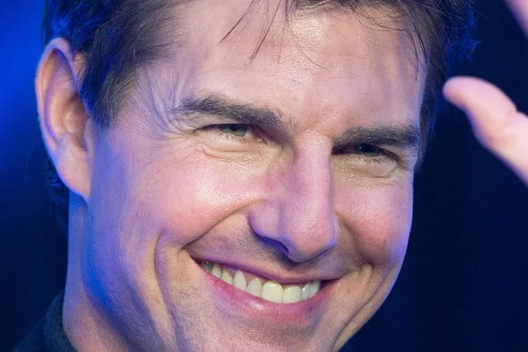 Actor Tom Cruise waves to his fans as he arrives at the China premiere of his movie "Oblivion" in Beijing Thursday, May 9, 2013. (AP Photo/Andy Wong)