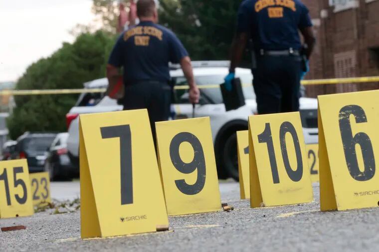 Numbered police evidence markers lined the asphalt at the scene of a shooting in the 1000 block of Wingohocking Street in Hunting Park last month.