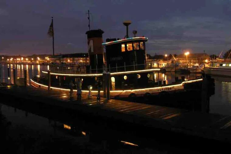 The 1902 tug Jupiter will lead Saturday's Seaport Parade of Lights on the Delaware at Penn's Landing. Sponsors hope the parade will become an annual event.