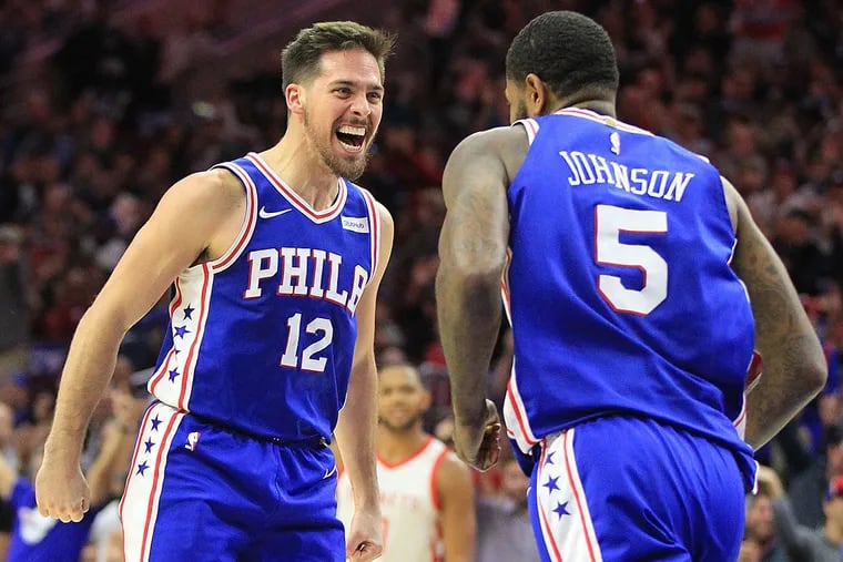 T.J. McConnell (left) and Amir Johnson after a McConnell steal and pass led to a Johnson dunk against the Houston Rockets.