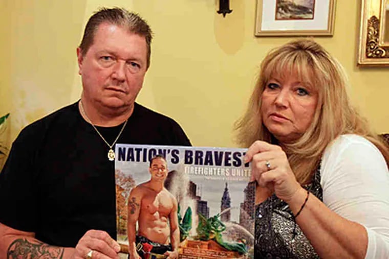 Jack and Gerry Slivinski urge supporters to buy a copy of the 'Nation's Bravest' calendar, the proceeds of which will benefit the widows of firefighters. Their son is featured on the calendar's cover. (David Maialetti/Staff)